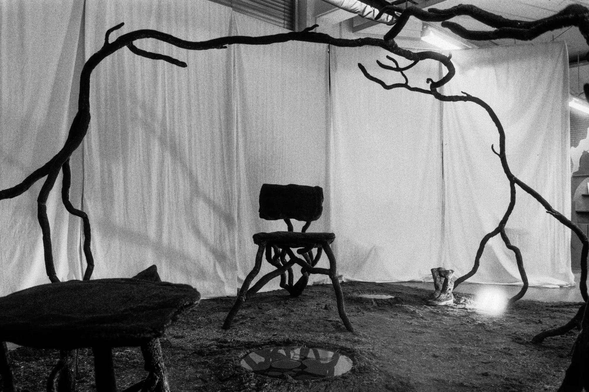 The installation from the opposite corner, ceiling visible past the curtain